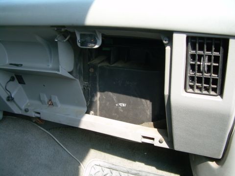 1988 Ford Bronco - The heater core housing and air vent are visible inside the vehicle's dashboard.