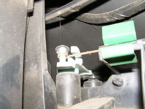 1988 Ford Bronco - Detail of a heater core cable actuator mechanism, showing plastic parts and a thin wire.