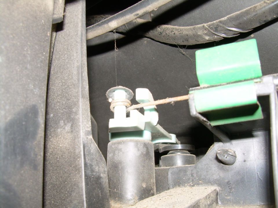 Heater control cable attached to white lever and green blend door actuator behind dash