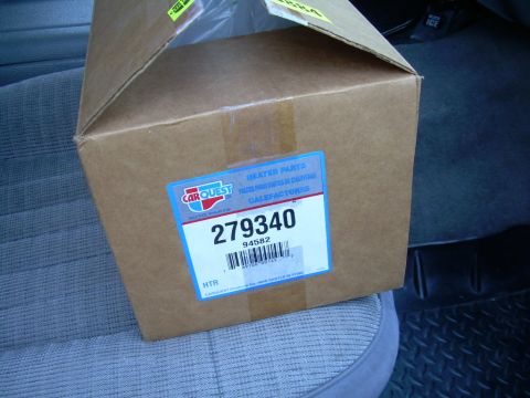 1988 Ford Bronco - A Carquest auto parts box for a heater core sits on a vehicle's seat.