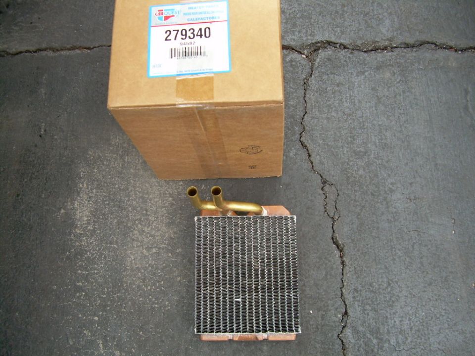 New CarQuest copper heater core part 279340 with brass tubes beside its box