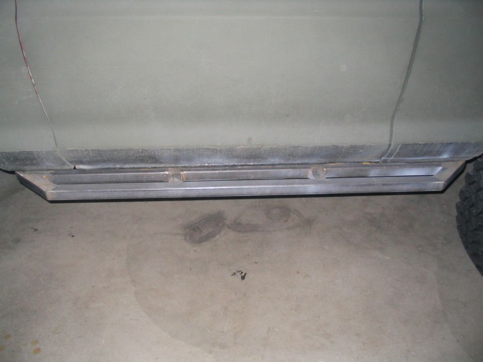Bare metal rocker panel or sill section below a vehicle body