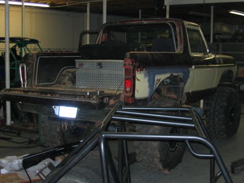 1992 Ford Mustang - Rear view of a lifted 1978 Ford Bronco with a roll cage and toolbox.