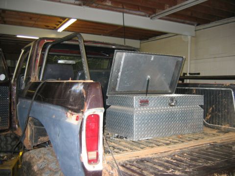 1992 Ford Mustang - 1973 Ford F-Series pickup truck with a roll cage and an open toolbox in the bed.