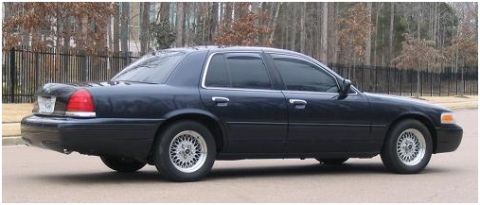 1999 Ford Crown Victoria - This 1999 Ford Crown Victoria is captured in a side profile, its classic sedan body style.
