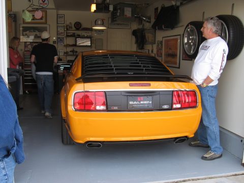 2007 Saleen S-302 - Rear view of a yellow 2007 Saleen S-302 Mustang in a garage with a man standing next to it.