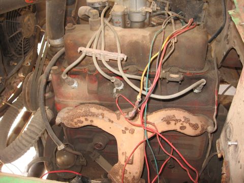 1986 Ford Bronco - Engine bay detail showing a V8 engine, wiring, and exhaust components.