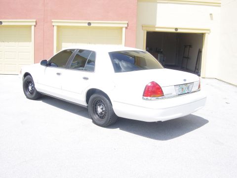 2000 Ford Crown Victoria - Rear view of a white 2000 Ford Crown Victoria sedan parked on a concrete surface.