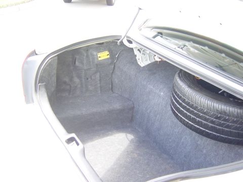 2000 Ford Crown Victoria - Car trunk interior with spare tire visible.