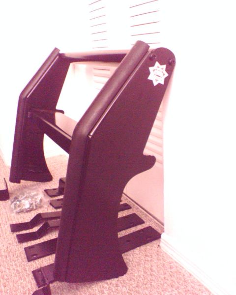 2000 Ford Crown Victoria - Angled indoor shot of a black push bar / grille guard standing on carpet, its wide flat wing panel carrying a small star-shaped police-styl…
