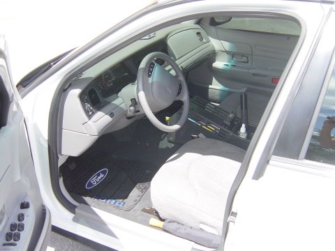 2000 Ford Crown Victoria - The interior of a 2000 Ford Crown Victoria, the dashboard and front seating area.