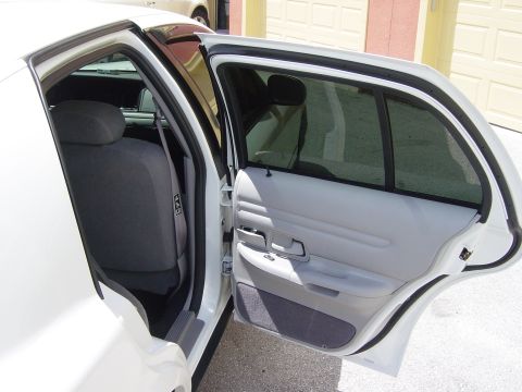 2000 Ford Crown Victoria - Interior view of a white 2000 Ford Crown Victoria, showing the rear passenger door and seating area.