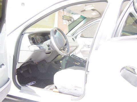 2000 Ford Crown Victoria - Interior view of a 2000 Ford Crown Victoria, highlighting the driver's side controls and seating area.