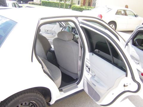 2000 Ford Crown Victoria - Interior view of a 2000 Ford Crown Victoria with rear doors open, showing the grey upholstery.