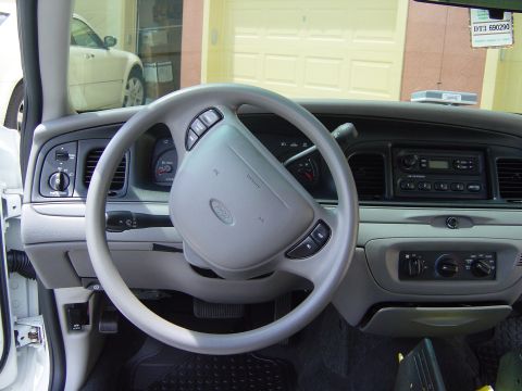 2000 Ford Crown Victoria - Interior view of a 2000 Ford Crown Victoria, focusing on the driver's side dashboard and steering wheel.