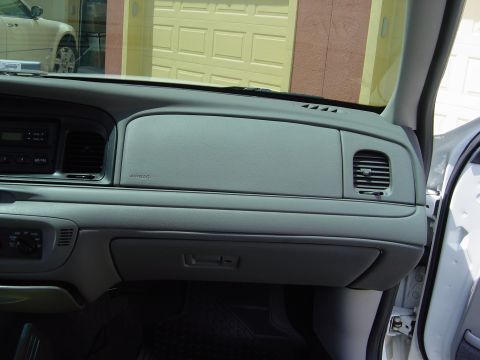 2000 Ford Crown Victoria - Interior view of a 2000 Ford Crown Victoria dashboard, with a garage door visible through the windshield.