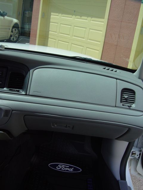 2000 Ford Crown Victoria - Interior view of a 2000 Ford Crown Victoria, showing the dashboard and floor mat.