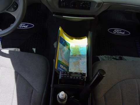 2000 Ford Crown Victoria - The interior of a car features Ford-branded floor mats and a Florida road map placed over the center console.