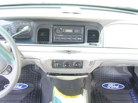2000 Ford Crown Victoria - The interior of a 2000 Ford Crown Victoria, with a focus on the dashboard and driver's side controls.