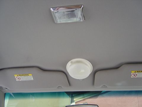 2000 Ford Crown Victoria - The interior of a vehicle shows the ceiling with two dome lights and two sun visors, one on each side.