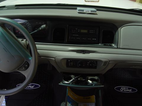 2000 Ford Crown Victoria - Interior view of a 2000 Ford Crown Victoria, showing the dashboard, steering wheel, and floor mats.