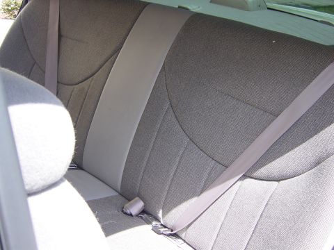 2000 Ford Crown Victoria - Interior view of a gray patterned rear seat with a beige stripe and a seatbelt.