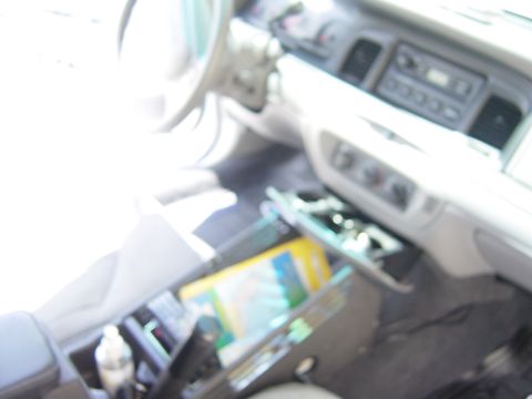 2000 Ford Crown Victoria - The interior of a 2000 Ford Crown Victoria is captured, highlighting the dashboard and center console area.