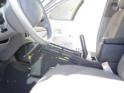 2000 Ford Crown Victoria - Interior view of a 2000 Ford Crown Victoria, likely a police vehicle, with custom console equipment.