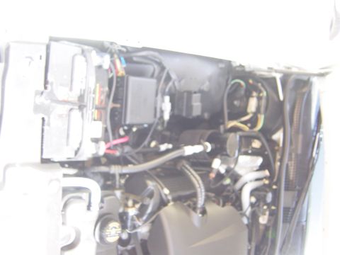 2000 Ford Crown Victoria - Close-up view of the complex wiring and plumbing within a vehicle's engine compartment.