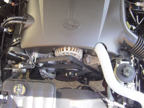 2000 Ford Crown Victoria - Close-up view of a vehicle's engine bay, showing the 4.6 liter engine components and drive belts.