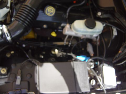 2000 Ford Crown Victoria - Engine bay of a 2000 Ford Crown Victoria, showing key components like the air intake and master cylinder.