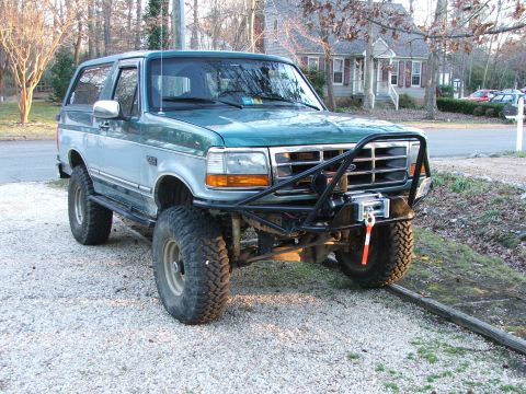 1996 Ford Bronco - This modified Ford Bronco features large off-road tires and a custom front bumper with a winch.