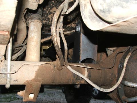 1996 Ford Bronco - Close-up view of the vehicle's undercarriage, highlighting suspension and drivetrain parts.
