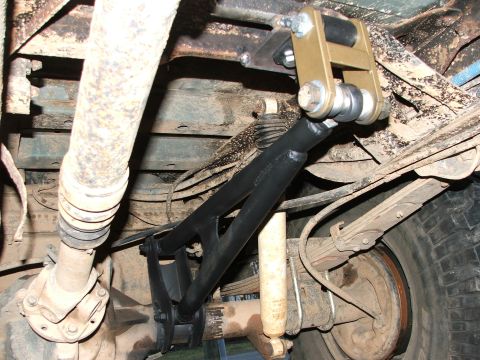 1996 Ford Bronco - This image shows the underside of a vehicle, focusing on modified suspension components like control arms and shock absorbers.