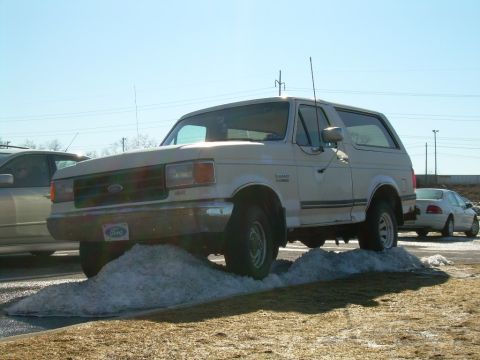 1988 Ford Bronco - This 1987 Ford Bronco is positioned on a mound of snow, with another car visible in the background.