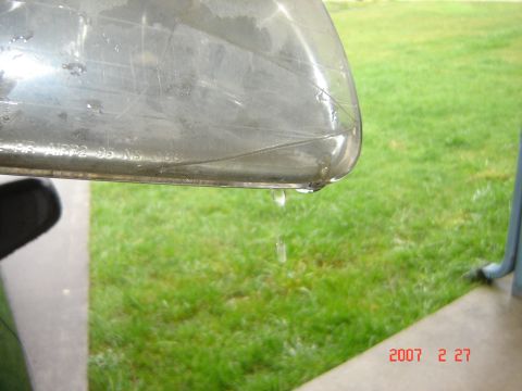 1997 Dodge Grand Caravan - A cracked headlight drips water, with a timestamp indicating it was photographed in 2007.