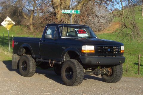 1994 Ford F-150 - This black 1994 Ford F-150 pickup truck is for sale and parked on a dirt road near Bunker Hill.
