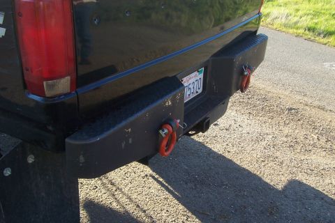 1994 Ford F-150 - Close-up of a truck's rear bumper heavy-duty tow hooks and a license plate.