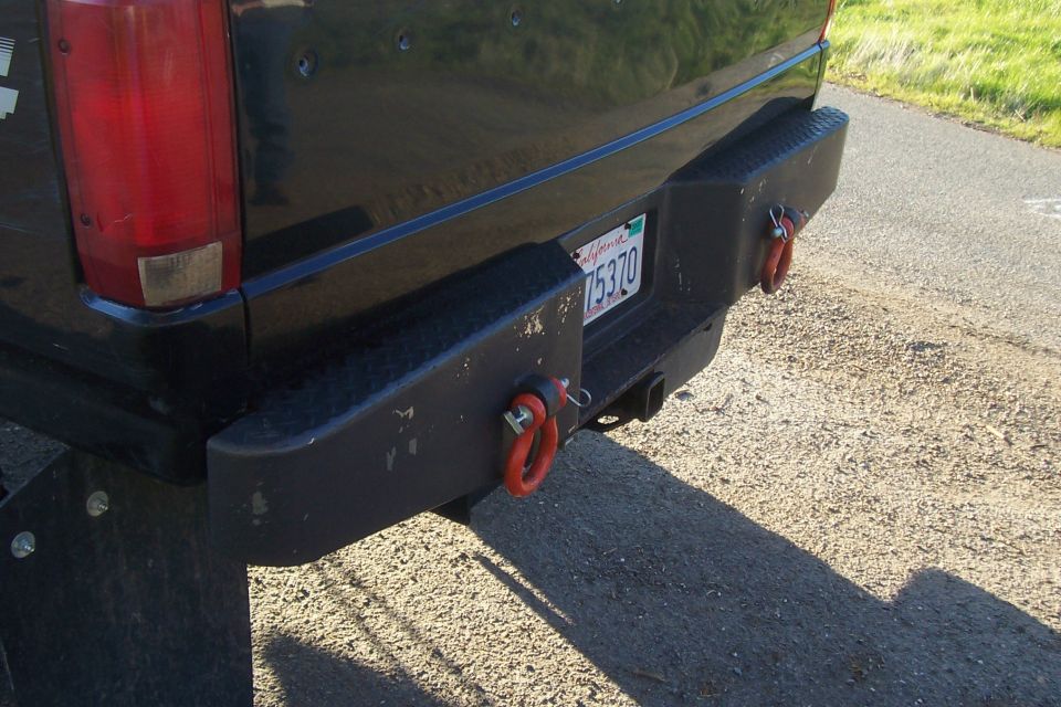 Rear bumper with red tow hooks and a California license plate reading 75370