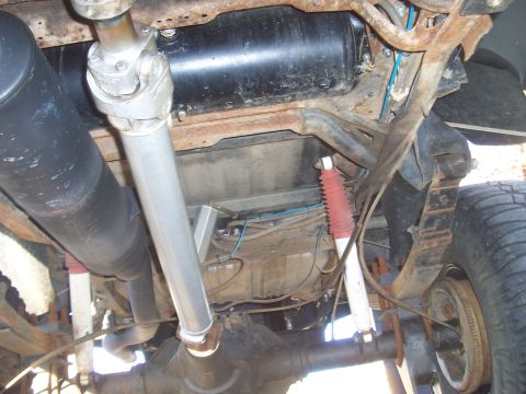 1994 Ford F-150 - Undercarriage view of a 1994 Ford F-150, highlighting the driveshaft, exhaust system, and rear suspension components.