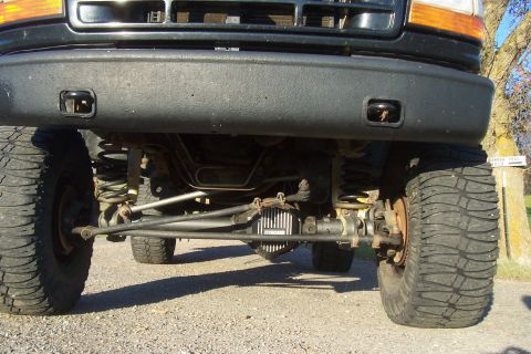 1994 Ford F-150 - Close-up view of the front suspension and differential of a heavy-duty truck.