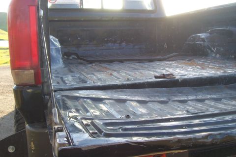 1994 Ford F-150 - Rear view of a 1994 Ford F-150 pickup truck bed, showing its condition and structure.