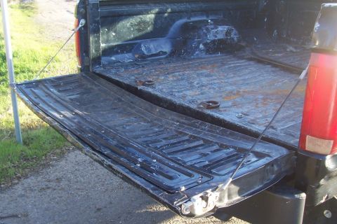 1994 Ford F-150 - The open tailgate and bed of a pickup truck show signs of wear and tear.