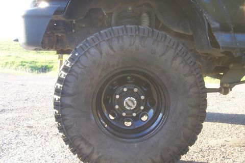 1994 Ford F-150 - Close-up of a truck's wheel and suspension system, with a watermark at the bottom right.