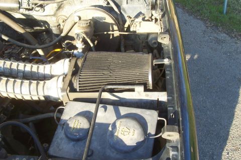 1994 Ford F-150 - Close-up of the engine bay, focusing on the air filter and coolant reservoir.