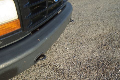 1994 Ford F-150 - Close-up of a Ford truck's front end, showing the grille and bumper with tow hooks.