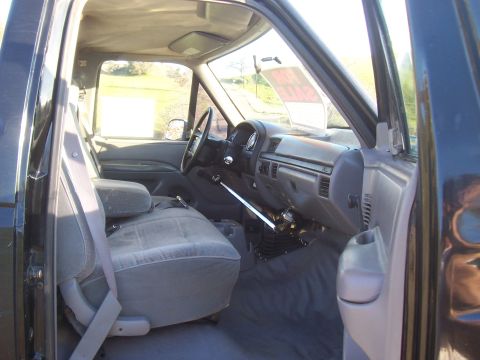 1994 Ford F-150 - The interior of a 1992 Ford F-150 pickup truck is visible from the driver's side door.