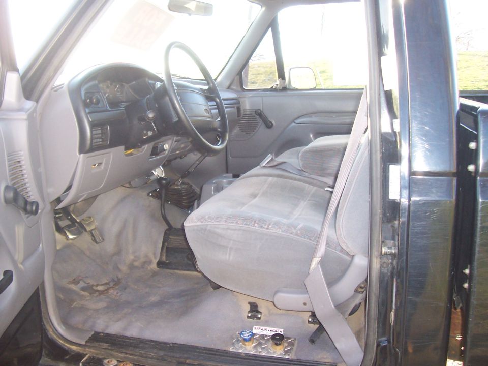1994 Ford F-150 interior showing dashboard, steering wheel, seats, and floor