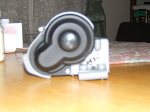 1988 Ford Bronco - A close-up view of a motorized component with a silver center and black housing.