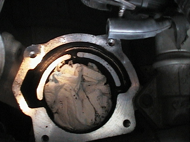 Close-up of engine part with rag stuffed inside
